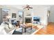 Comfortable living room featuring a fireplace, ceiling fan, hardwood floors and modern furnishings at 8645 Coors St, Arvada, CO 80005