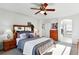 Spacious main bedroom with a ceiling fan, wood furniture, and an ensuite bathroom with a soaking tub at 8645 Coors St, Arvada, CO 80005