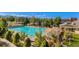 Community pool featuring a large pool, sun loungers, and well-manicured landscaping at 8645 Coors St, Arvada, CO 80005