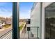 View of the residential street from home's balcony with iron railing at 3220 W 20Th Ave # 1, Denver, CO 80211