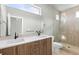Bright bathroom features double vanity with tiled backsplash, walk-in shower, and toilet at 3220 W 20Th Ave # 1, Denver, CO 80211
