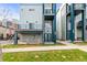Modern townhome featuring a sleek blue and gray facade, private balconies, and well-maintained landscaping at 3220 W 20Th Ave # 1, Denver, CO 80211