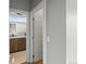 Hallway with view into bathroom which features wood vanity and large mirror at 3220 W 20Th Ave # 1, Denver, CO 80211