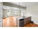 Open concept kitchen with stainless steel appliances, island, and hardwood floors at 3220 W 20Th Ave # 1, Denver, CO 80211
