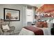Bedroom with accent wall and wicker chair at 16939 Black Rose Cir, Parker, CO 80134
