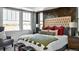 Main bedroom with tufted headboard and large windows at 16939 Black Rose Cir, Parker, CO 80134