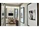 Bright hallway with framed artwork and view into living area at 16939 Black Rose Cir, Parker, CO 80134