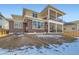 Rear view of a two-story home showing outdoor deck and patio at 1875 Hickory Ave, Erie, CO 80516
