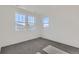 Bright bedroom with large windows and neutral gray carpet flooring at 1875 Hickory Ave, Erie, CO 80516