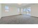Large open bedroom with big windows and a sliding glass door to outdoor balcony at 1875 Hickory Ave, Erie, CO 80516