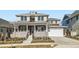 Beautiful two-story home with a welcoming front porch, two-car attached garage, and modern architectural details at 1875 Hickory Ave, Erie, CO 80516