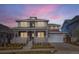 Stunning two-story home featuring a welcoming front porch, attached garage, and a beautifully landscaped yard at 1875 Hickory Ave, Erie, CO 80516