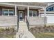 Inviting front porch with stylish columns, brick accents, and a charming entrance to the home at 1875 Hickory Ave, Erie, CO 80516