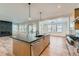 Bright open-concept kitchen with island, stainless steel appliances and connection to the living room at 1875 Hickory Ave, Erie, CO 80516