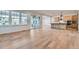 Spacious living room featuring sleek hardwood floors, open layout, and sliding glass doors at 1875 Hickory Ave, Erie, CO 80516