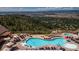 Breathtaking aerial view of the community pool and sun deck with umbrellas and ample seating at 858 Swandyke Dr, Castle Rock, CO 80108