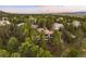 Aerial view of a home surrounded by lush green trees in a tranquil neighborhood at 858 Swandyke Dr, Castle Rock, CO 80108