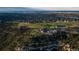 Breathtaking aerial view showcasing the golf course, clubhouse, and surrounding residential area with natural beauty at 858 Swandyke Dr, Castle Rock, CO 80108