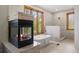 Modern bathroom featuring a soaking tub, a walk-in shower, and a cozy fireplace at 858 Swandyke Dr, Castle Rock, CO 80108