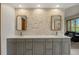 Stylish bathroom with a dual sink vanity, a stone accent wall, and modern fixtures, creating a spa-like retreat at 858 Swandyke Dr, Castle Rock, CO 80108