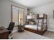 Cozy bedroom boasts a wooden bunk bed, large window with plantation shutters, and a comfortable workspace at 858 Swandyke Dr, Castle Rock, CO 80108