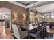 Elegant dining room featuring a brick accent wall, hardwood floors, and stylish lighting fixtures, great for gatherings at 858 Swandyke Dr, Castle Rock, CO 80108