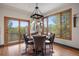 Elegant dining room with hardwood floors, a stylish light fixture, and scenic views from large windows at 858 Swandyke Dr, Castle Rock, CO 80108