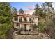 Back exterior of a multi-story home with large windows, decks, and lush landscaping at 858 Swandyke Dr, Castle Rock, CO 80108