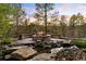 Stone fire pit with built-in seating, perfect for enjoying evenings with nature views at 858 Swandyke Dr, Castle Rock, CO 80108