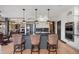 Bright kitchen featuring a central island with seating, modern appliances, and stylish pendant lighting at 858 Swandyke Dr, Castle Rock, CO 80108