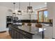 Contemporary kitchen featuring a large island with a cooktop, granite countertops, and ample cabinet space at 858 Swandyke Dr, Castle Rock, CO 80108