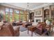 Inviting living room with large windows, a stone fireplace, and comfortable seating, creating a warm atmosphere at 858 Swandyke Dr, Castle Rock, CO 80108