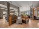 Spacious living area with hardwood floors, dark accent columns, and views of the surrounding landscape at 858 Swandyke Dr, Castle Rock, CO 80108