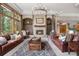 Living room features a fireplace, built-in shelving, and comfortable leather sofas at 858 Swandyke Dr, Castle Rock, CO 80108