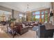 Open living room with large windows offering views, hardwood floors, and modern furnishings at 858 Swandyke Dr, Castle Rock, CO 80108