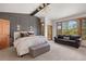 Spacious main bedroom with a decorative wall, a sitting area, and large windows offering natural views at 858 Swandyke Dr, Castle Rock, CO 80108