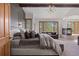 Luxurious main bedroom with a fireplace, a seating area, and large windows offering scenic views at 858 Swandyke Dr, Castle Rock, CO 80108