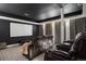 Comfortable movie room with theater seating, large screen, and dark walls for an immersive experience at 858 Swandyke Dr, Castle Rock, CO 80108