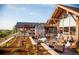 Outdoor patio area featuring comfortable seating, a stone fireplace, and scenic views, perfect for social gatherings at 858 Swandyke Dr, Castle Rock, CO 80108