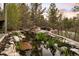 Backyard featuring a pond, fire pit, stone retaining wall, and seating, offering a relaxing outdoor space at 858 Swandyke Dr, Castle Rock, CO 80108