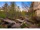 Stunning water feature integrated with natural rock formations and landscaping, creating a tranquil outdoor space at 858 Swandyke Dr, Castle Rock, CO 80108