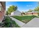 Private backyard showcasing a detached garage and lush greenery at 6506 Lee St, Arvada, CO 80004