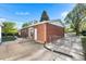 This home's backyard has an inviting patio and is enclosed by a chain link fence at 6506 Lee St, Arvada, CO 80004