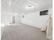 Large finished basement offers versatile space with cozy carpeting and ample lighting at 6506 Lee St, Arvada, CO 80004