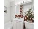 Charming bathroom featuring a bathtub, a stylish mirror, and a modern vanity with tasteful floral decorations at 6506 Lee St, Arvada, CO 80004