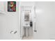 Bright bathroom featuring a pedestal sink, modern lighting, and decorative wall art at 6506 Lee St, Arvada, CO 80004