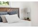 Bedroom featuring a modern wooden headboard, plush pillows, and a stylish lamp on the nightstand at 6506 Lee St, Arvada, CO 80004