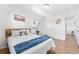 Bright bedroom featuring hardwood floors, a white bed with decorative pillows, and a serene atmosphere at 6506 Lee St, Arvada, CO 80004