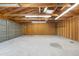 Spacious garage interior with high ceilings, exposed wood, and ample storage or parking space at 6506 Lee St, Arvada, CO 80004