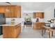 Bright kitchen featuring wooden cabinets, light countertops, stainless steel appliances, and an adjacent dining area at 6506 Lee St, Arvada, CO 80004